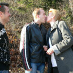 Horny mature slut sucking two guys in the woods
